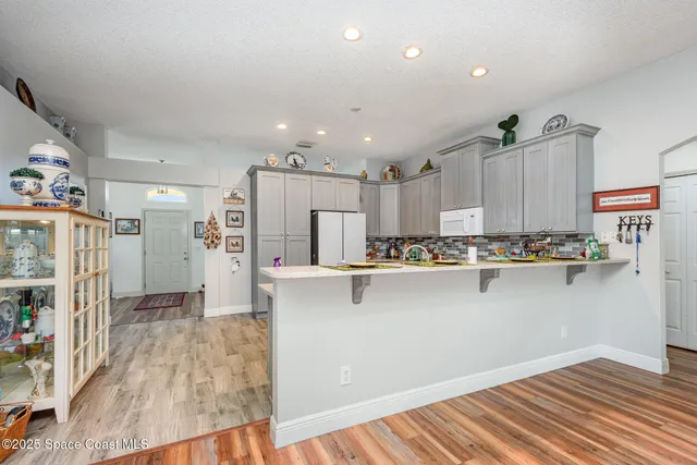 a kitchen with stainless steel appliances granite countertop a refrigerator and a stove top oven