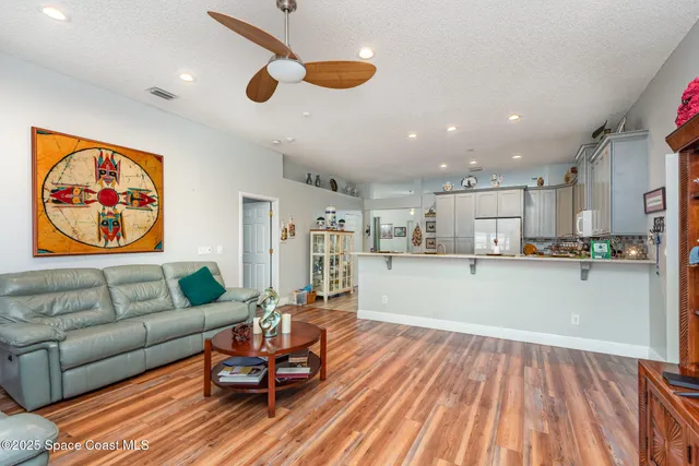 a living room with kitchen island furniture and a wooden floor