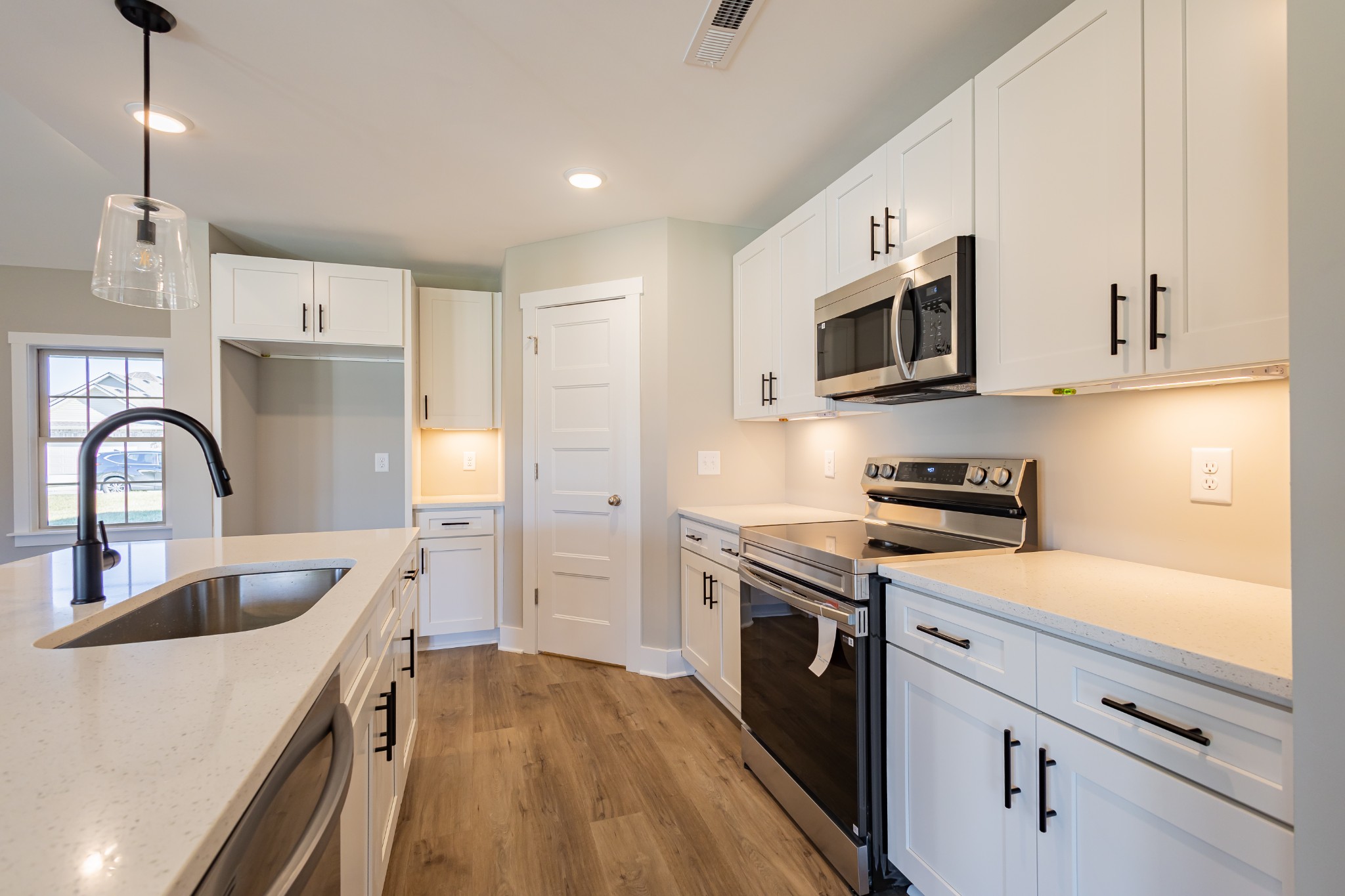 42 Brooklyn Avenue Manchester, TN 37355 - Photo 24 of 64 a kitchen with stainless steel appliances granite countertop a stove top oven a sink dishwasher and a refrigerator with wooden floor