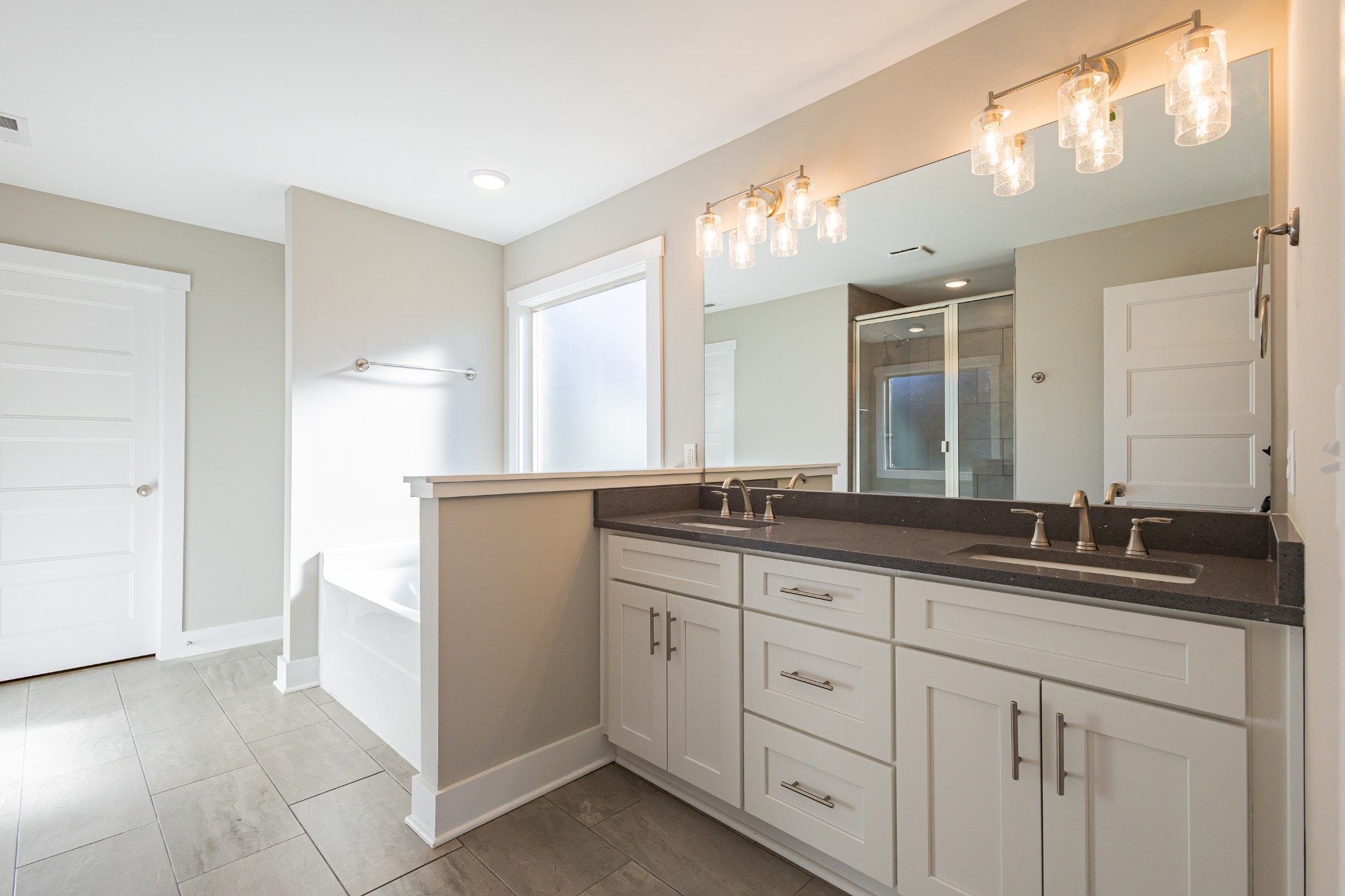 42 Brooklyn Avenue Manchester, TN 37355 - Photo 37 of 64 a bathroom with double sink and a mirror