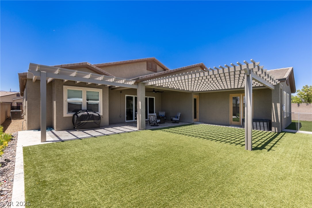 7036 Arabian Ridge Street Las Vegas, NV 89131 - Photo 46 of 64 Spacious covered patio with extended pergolas for additional shade. Large turf areas with plenty of space.