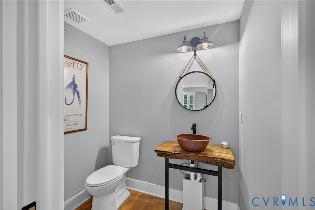 2122 Jockey Ridge Road Maidens, VA 23102 - Photo 45 of 63 a bathroom with a toilet a sink and mirror