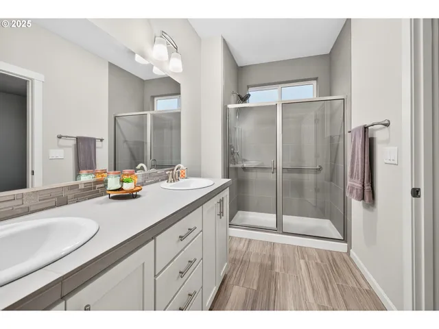 a bathroom with a shower sink and mirror