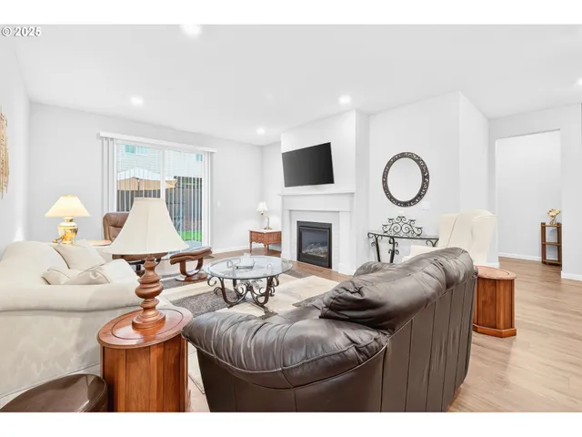 a living room with furniture a fireplace and a flat screen tv
