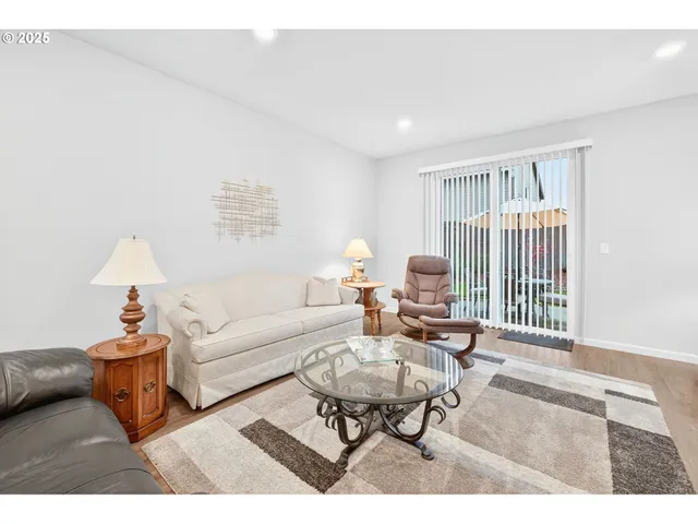 a living room with furniture a table and a lamp