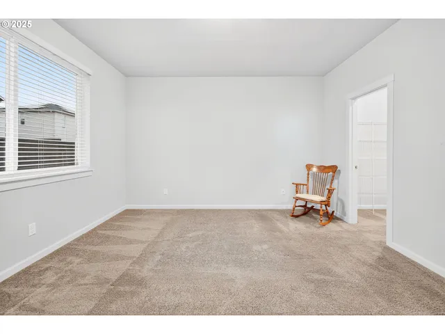 a view of a room with furniture and a window