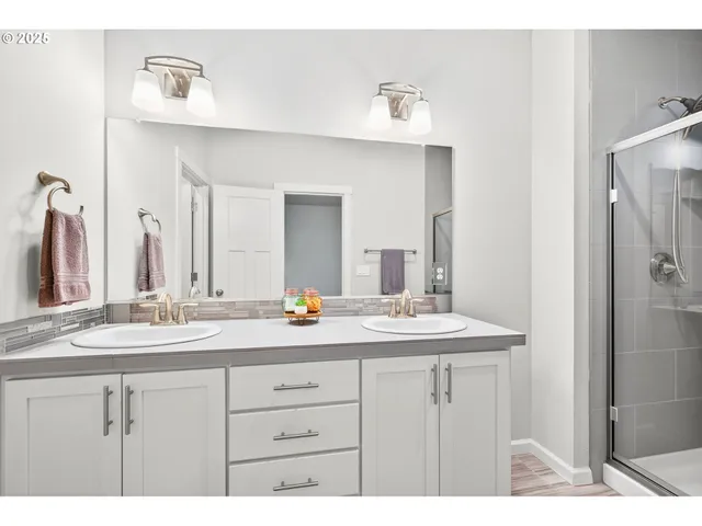a bathroom with a sink double vanity and a mirror