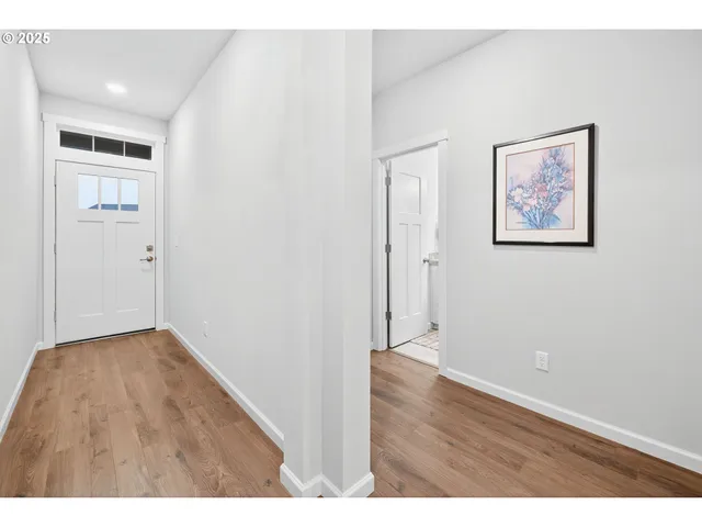 a view of an empty room with wooden floor