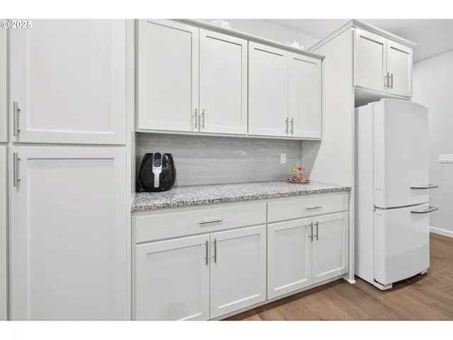 a kitchen with stainless steel appliances granite countertop a refrigerator sink and cabinets