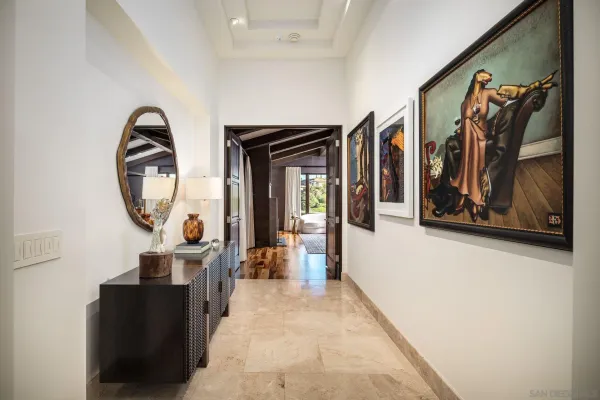 a living room with furniture and a painting on the wall