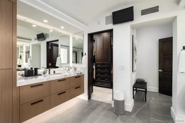 a bathroom with a double vanity sink and a mirror