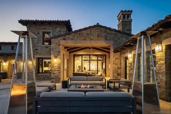 a view of a patio with a table and chairs