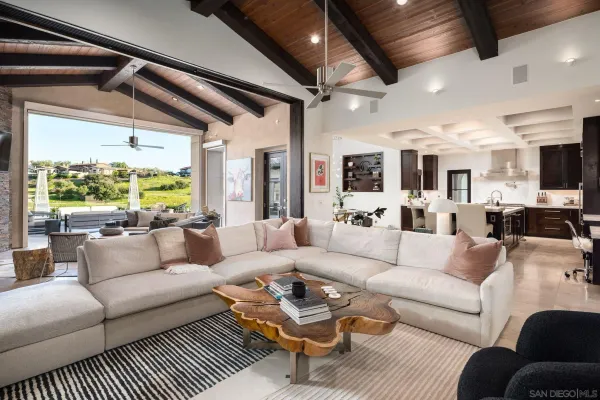 a living room with furniture a flat screen tv and a large window