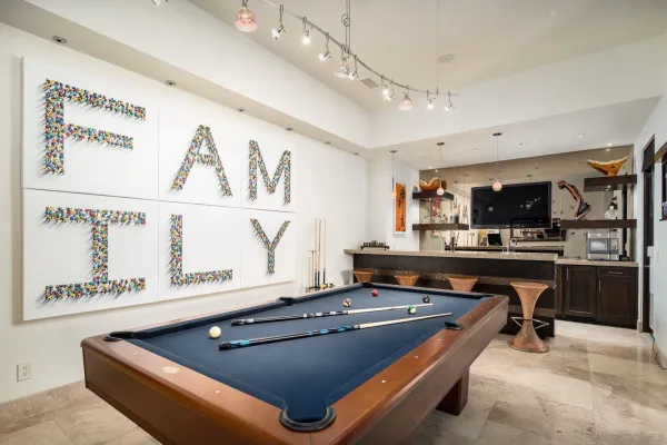 a room with furniture pool table and flat screen tv