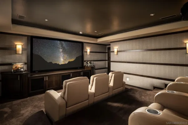 a media room with lots of chairs and a projector screen