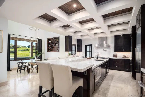 a large kitchen with a table and chairs