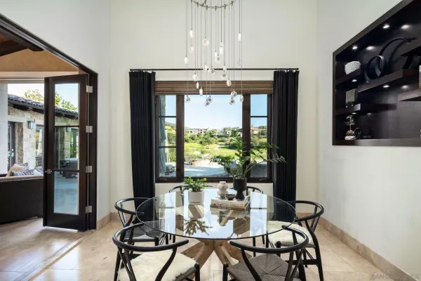 a dining room with furniture a chandelier and window