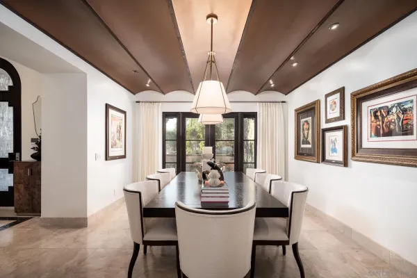 a dining room with furniture a chandelier and window