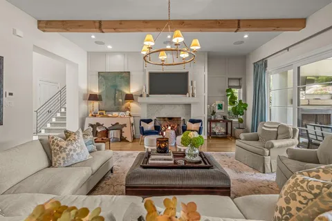 a living room with furniture a fireplace and a flat screen tv