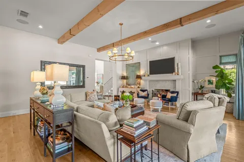 a living room with fireplace furniture and a flat screen tv