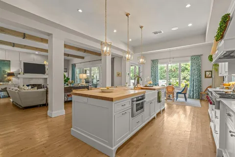 a large kitchen with stainless steel appliances granite countertop a stove and cabinets