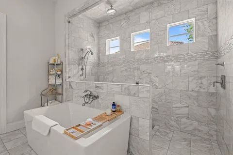 a bathroom with a sink a bath tub and a shower