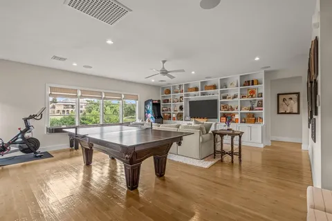 a living room with furniture a flat screen tv and a large window