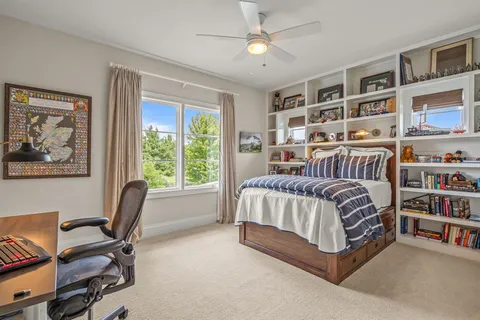 a bed room with a bed and a chair