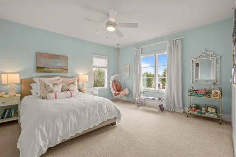 a spacious bedroom with a bed and a large window