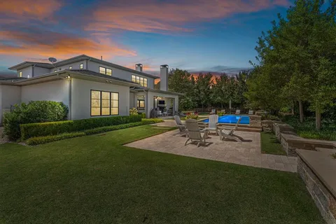a view of a house with sitting area and garden