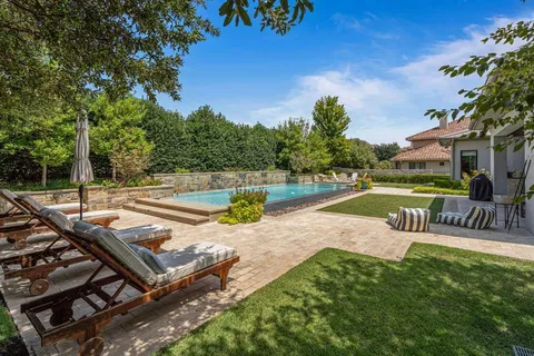 a view of a swimming pool with a patio