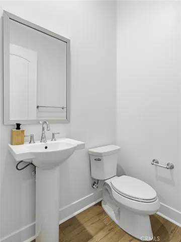 a bathroom with a sink a toilet and mirror