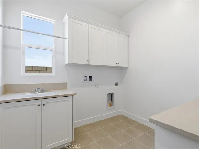 a view of cabinets and utility room with window