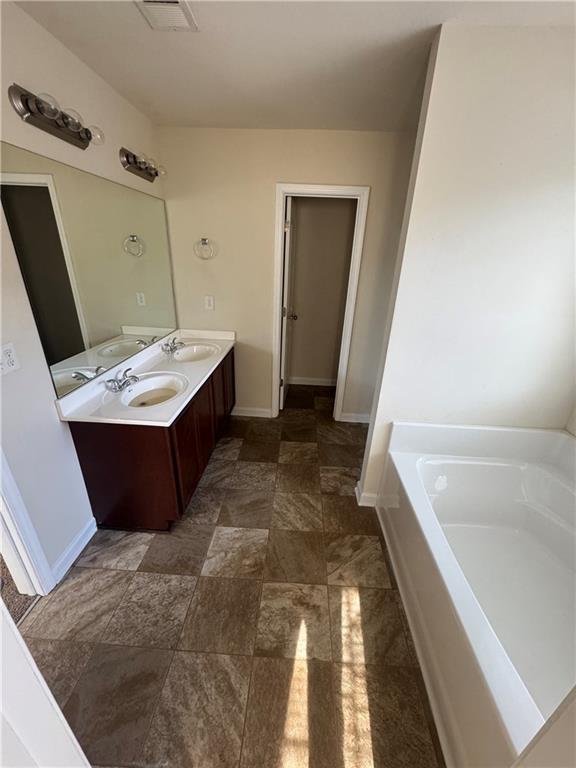 1579 Leonard Street Hampton, GA 30228 - Photo 11 of 25 a bathroom with a tub sink and mirror
