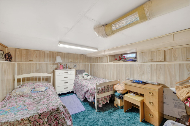 977 23rd Street Ogden, UT 84401 - Photo 25 of 29 Bedroom featuring wooden walls and dark carpet