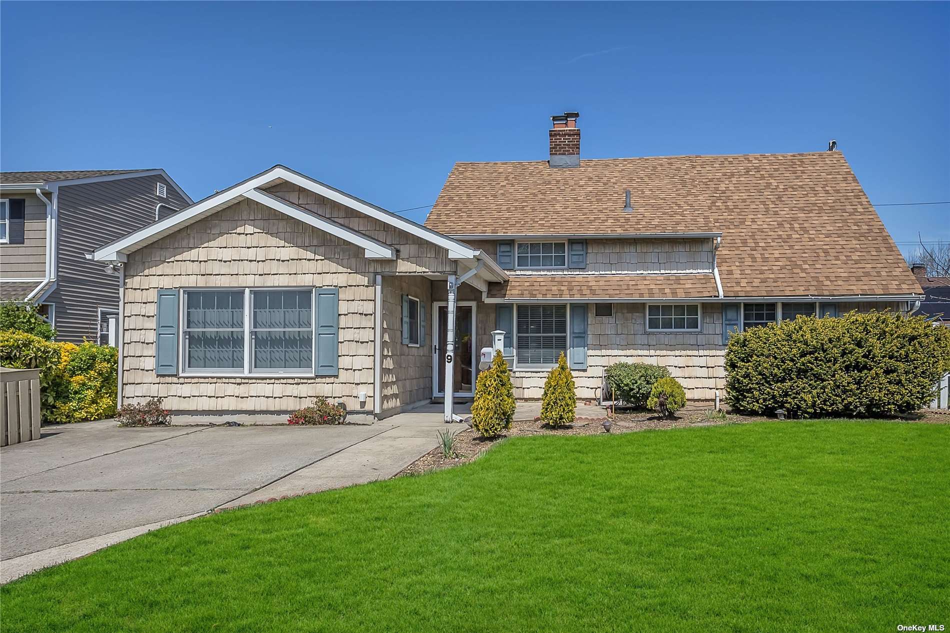 a front view of a house with a yard and porch
