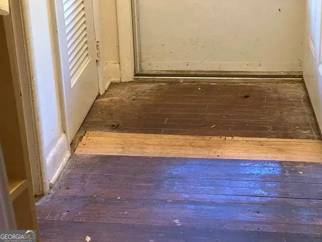a view of a room with wooden floor