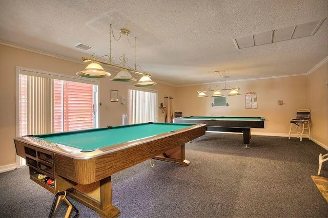 a room with pool tables and windows