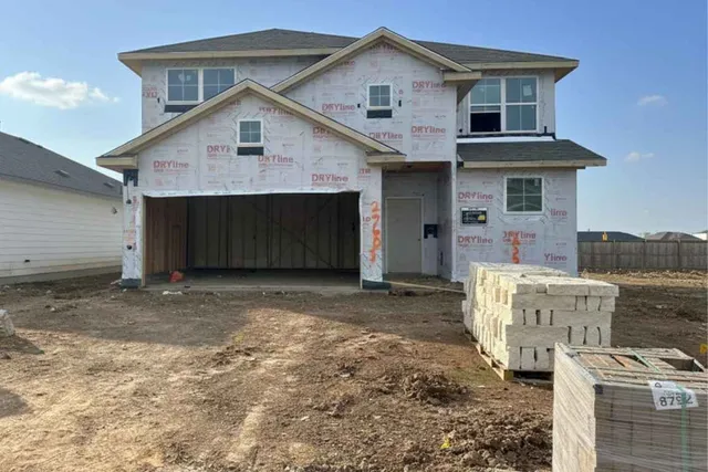a view of a house with a yard and garage