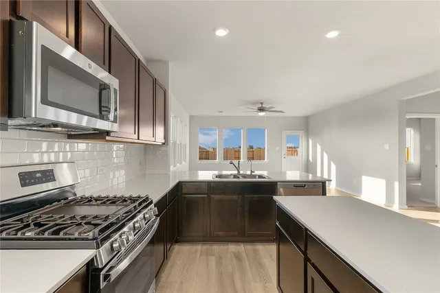 a bathroom with a double vanity sink a toilet and shower