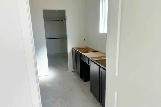 a kitchen with a refrigerator and a stove