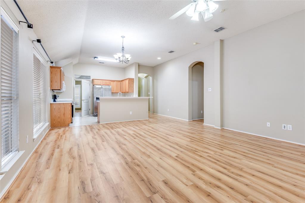 4921 Tulip Lane Fort Worth, TX 76137 - Photo 2 of 12 a large kitchen with kitchen island a stove a sink dishwasher a refrigerator and wooden floor
