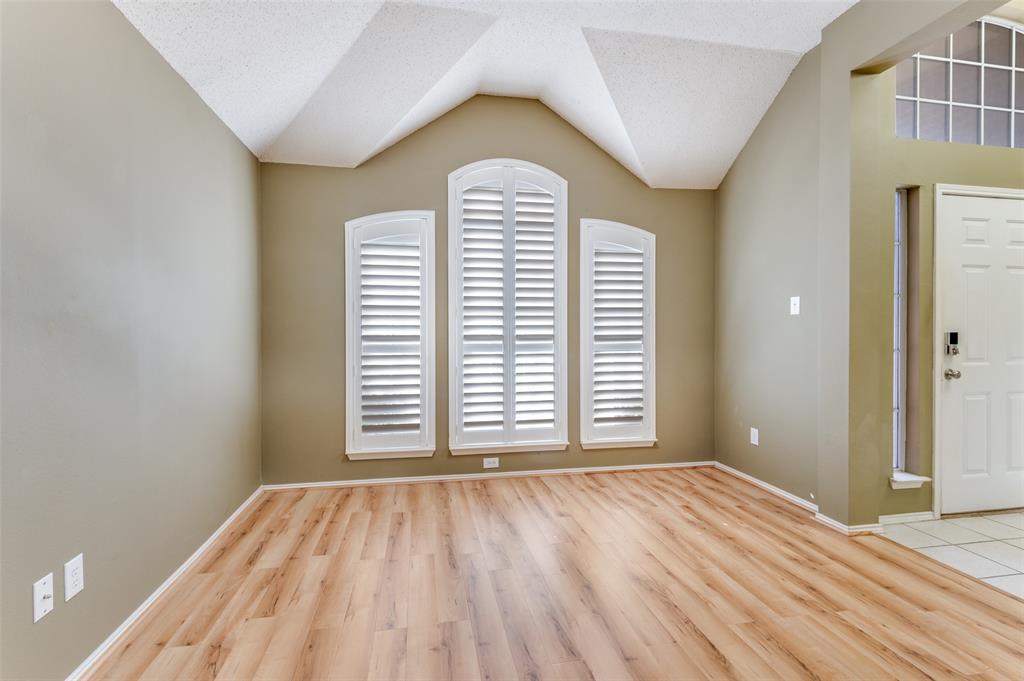4921 Tulip Lane Fort Worth, TX 76137 - Photo 6 of 12 a view of empty room with wooden floor and fan