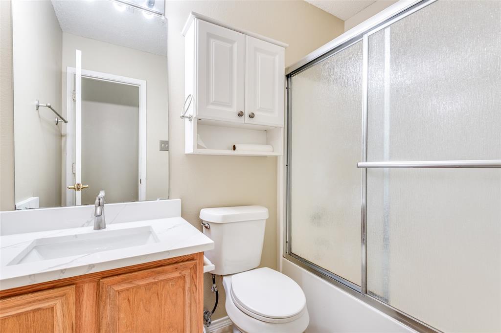 4921 Tulip Lane Fort Worth, TX 76137 - Photo 7 of 12 a bathroom with a sink a toilet and shower