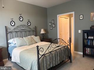 700 Cattail Cove, Unit 207 Cambridge, MD 21613 - Photo 16 of 29 a bedroom with a bed and a book shelf