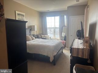 700 Cattail Cove, Unit 207 Cambridge, MD 21613 - Photo 20 of 29 a bedroom with a bed and wooden floor