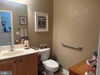 700 Cattail Cove, Unit 207 Cambridge, MD 21613 - Photo 22 of 29 a bathroom with a sink mirror and toilet