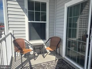 700 Cattail Cove, Unit 207 Cambridge, MD 21613 - Photo 24 of 29 a chair and a table in a balcony