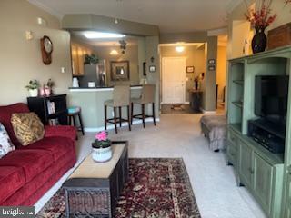700 Cattail Cove, Unit 207 Cambridge, MD 21613 - Photo 5 of 29 a living room with furniture and a flat screen tv