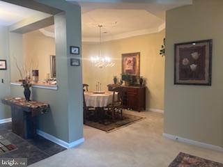 700 Cattail Cove, Unit 207 Cambridge, MD 21613 - Photo 7 of 29 a dining room with table and chairs